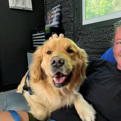 Kelly Walker alongside a golden retriever during a training session